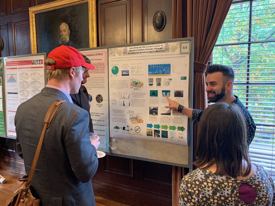 Eric Matzner presenting early Project Vesta research to three people
