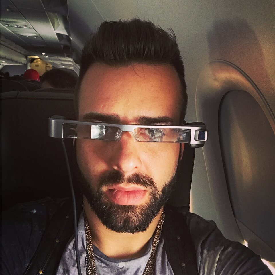 Eric Matzner testing projection glasses on an airplane
